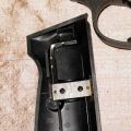 Umarex Walther PPK showing concealed key for butt assembly insidel L grip plate, closeup
