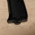 Umarex Walther PPK with knurled, oil blued butt screw assembly, closeup